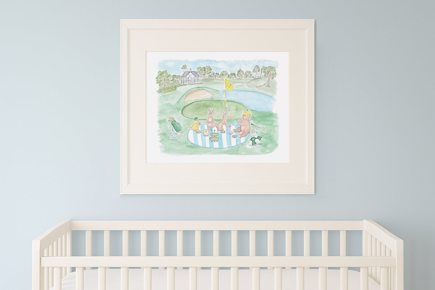 Framed children's illustration above a crib with a light blue wall background