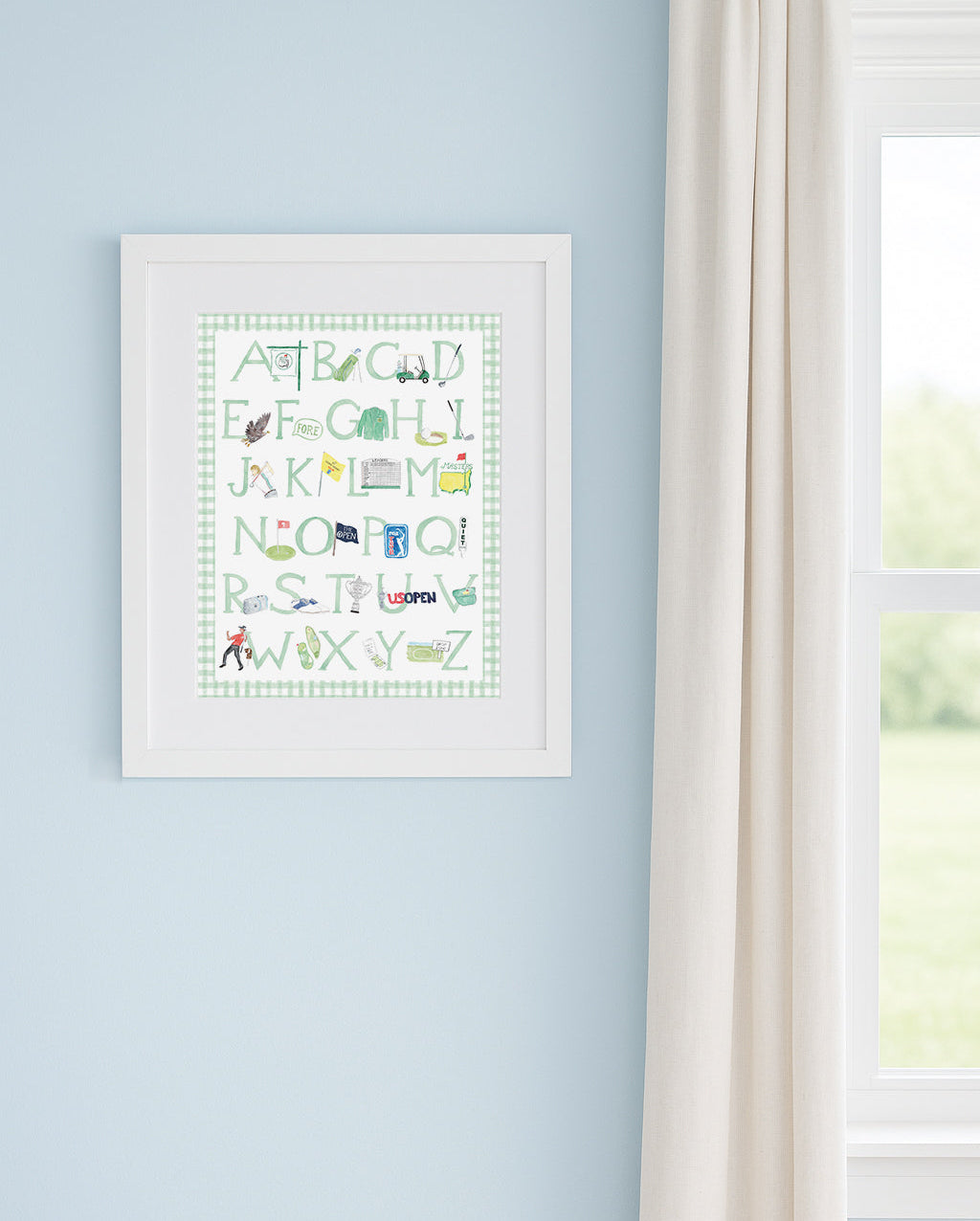 Framed golf alphabet art on a light blue wall next to a window.