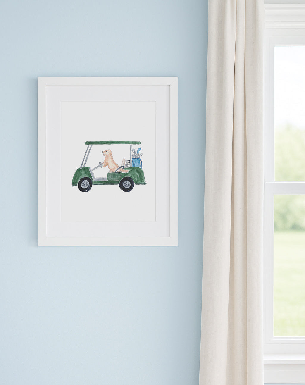 Framed artwork of a golf cart with a dog on a light blue wall.