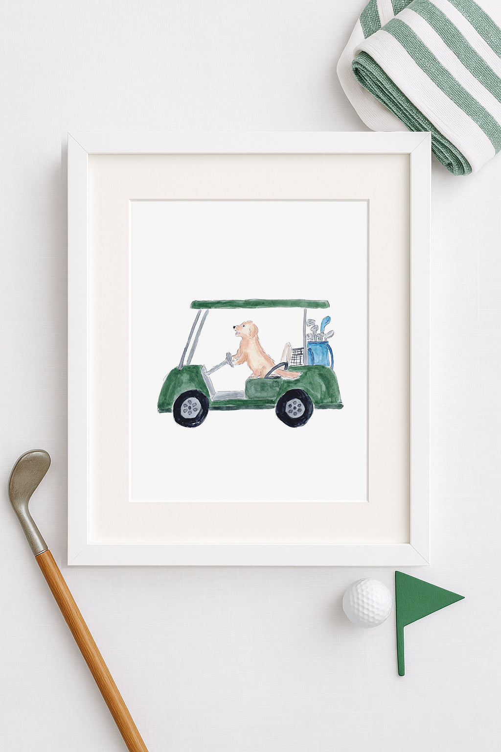 Framed artwork of a dog driving a golf cart on a white surface.